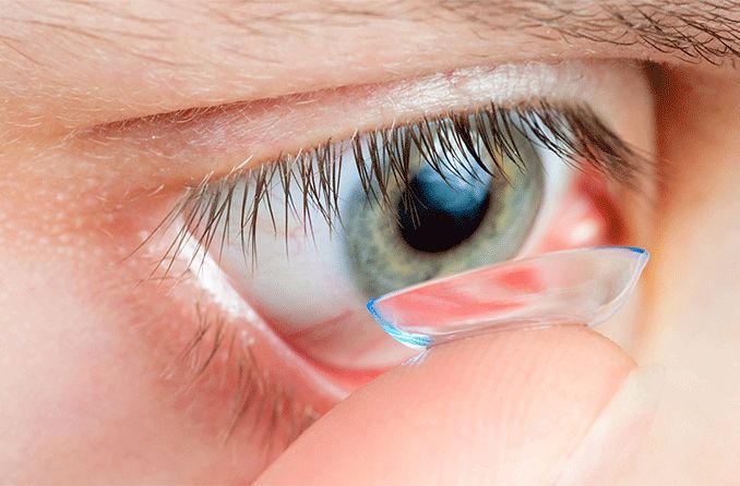 person applying a contact lens